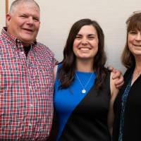 Emily and parents pose for picture